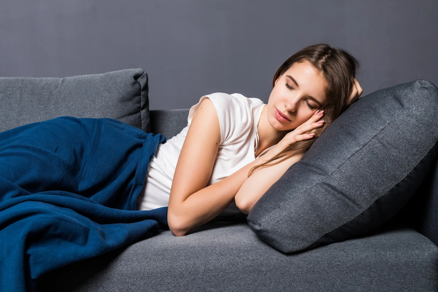 Woman sleep well, lying down on sofa bed